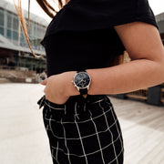 Silver and black Stainless Steel Chronograph Watch with a black Full Grain Leather Strap for women by GenerationNow, Model Prometheus, worn by model
