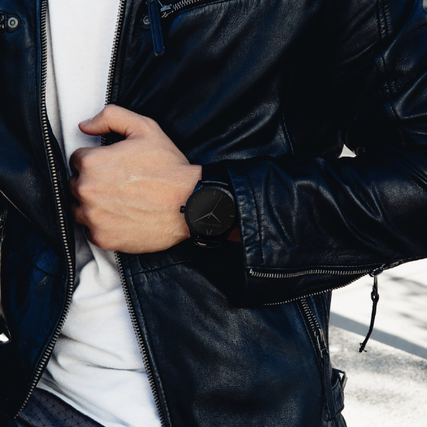 Black Stainless Steel Classic Watch with a black Full Grain Leather Strap for men by GenerationNow, Model The Drak Knight, worn by model